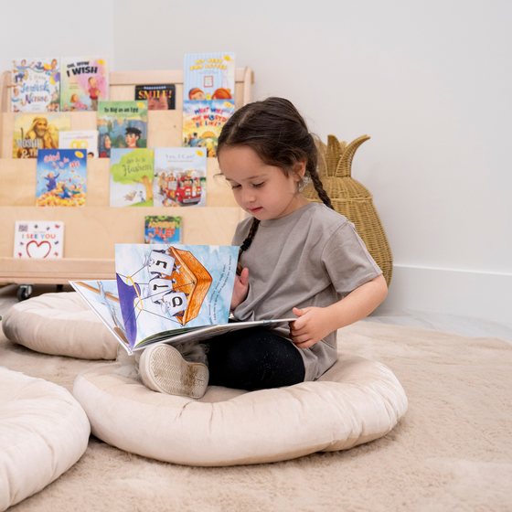A child reading quietly in the cozy corner