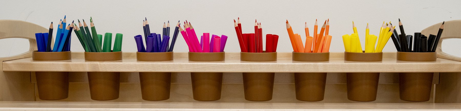 A row of colored pencils sorted by color
